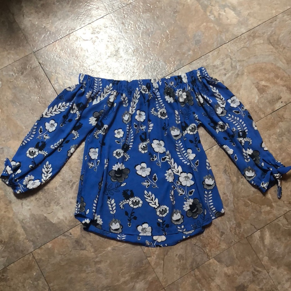 Off-the-shoulder blue floral long sleeve blouse.